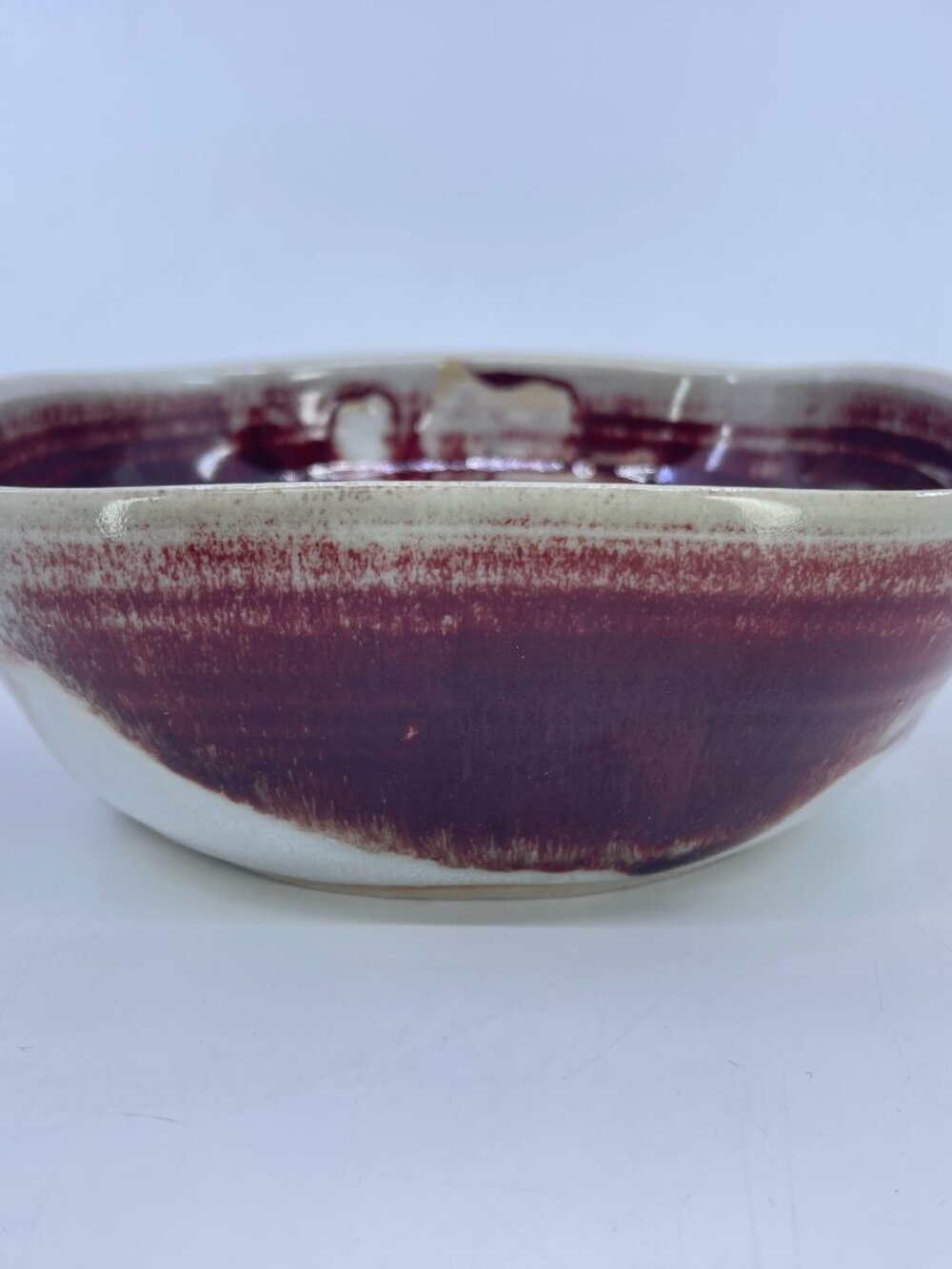 vintage hand thrown studio pottery bowl with ox blood glaze signed by artist
